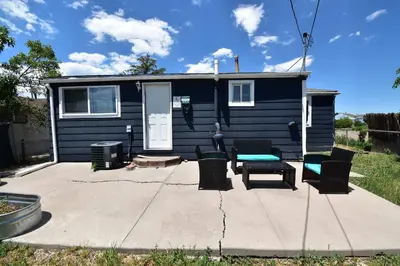 a blue tiny house with chairs and a patio at Dog Friendly and Family Sized Home in Denver Perfect for Your Furry Friend in Denver