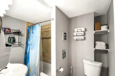 a bathroom with a shower and a toilet and towels at Dog Friendly and Family Sized Home in Denver Perfect for Your Furry Friend in Denver