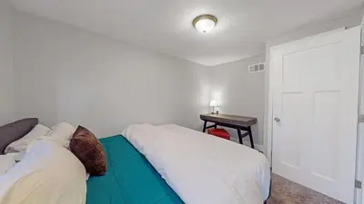 a bedroom with a couch and a table and a door at Southwest Charm Spacious Family Home Near Denver in Denver