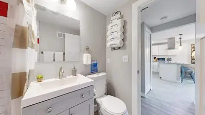 a white bathroom with a toilet and a sink at Southwest Charm Spacious Family Home Near Denver in Denver
