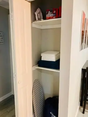 a closet with a chair and some towels on shelves at Southwest Charm Spacious Family Home Near Denver in Denver