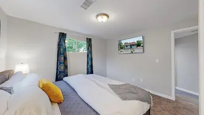 a bedroom with a bed and a window at Southwest Charm Spacious Family Home Near Denver in Denver