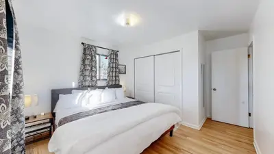 a white bedroom with a large bed with white pillows at Spacious Arvada Family Home with King Beds and Office in Arvada