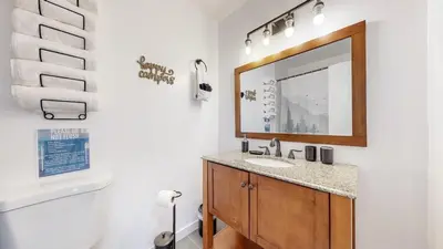 a bathroom with a sink and a mirror at Spacious Arvada Family Home with King Beds and Office in Arvada