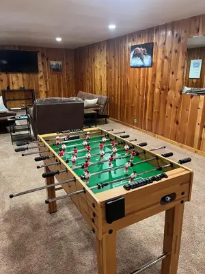 a foosball table in a living room at Spacious Arvada Family Home with King Beds and Office in Arvada