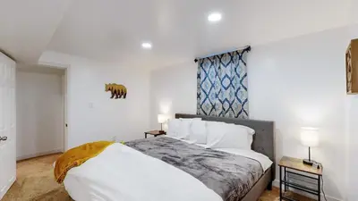 a bedroom with a large bed and a window at Spacious Arvada Family Home with King Beds and Office in Arvada