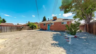 a brick house with a fence in a yard at Cozy Lower Unit Retreat in Denver in Denver