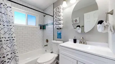 a bathroom with a sink and a toilet and a mirror at Bright & Spacious Upper Unit with Two Bedrooms in Denver in Denver