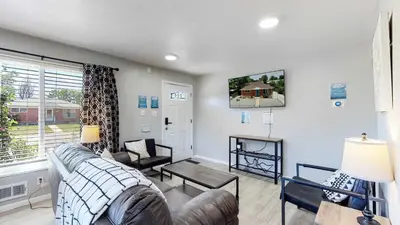 a living room with a couch and a table at Bright & Spacious Upper Unit with Two Bedrooms in Denver in Denver