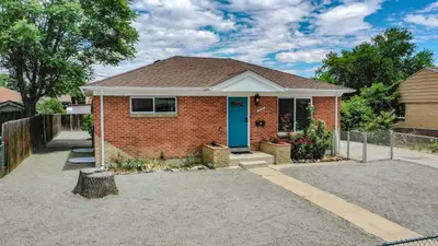a red brick house with a blue door at Bright & Spacious Upper Unit with Two Bedrooms in Denver in Denver