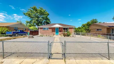 a fence in front of a house at Bright & Spacious Upper Unit with Two Bedrooms in Denver in Denver