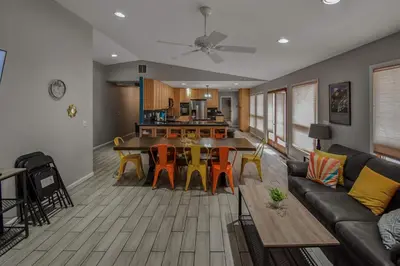 a living room with a couch and a table and chairs at Sunny Family Home in Denver with huge yard and hot tub in Denver