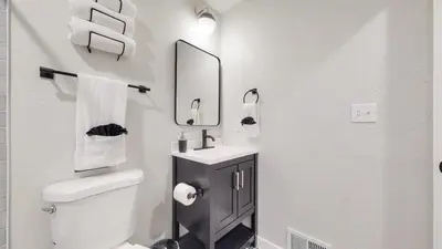 a bathroom with a toilet and a sink and a mirror at Spacious Family Retreat in Denver in Denver