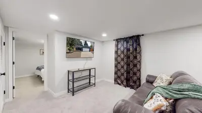 a living room with a couch and a bedroom at Spacious Family Retreat in Denver in Denver