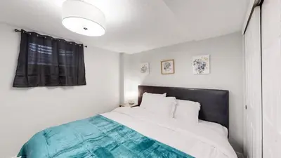 a bedroom with a large bed with a black headboard at Spacious Family Retreat in Denver in Denver