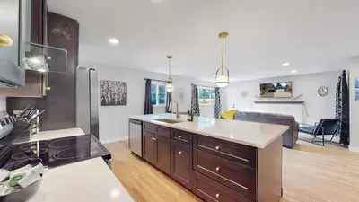 a kitchen and living room with a large island in a kitchen at Spacious Family Retreat in Denver in Denver