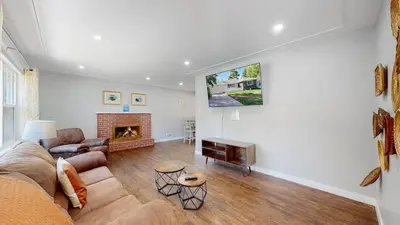 a living room with a couch and a fireplace at Stunning Upper Family Unit with King Beds & Yard in Denver