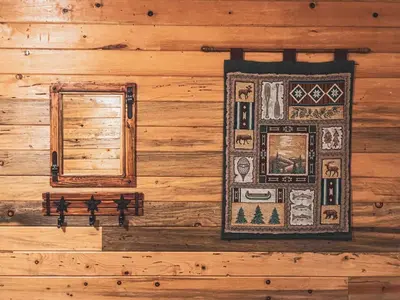 a wall of a log cabin with a window at Kinnikinnick Retreat Steps from the Lake and Board walk, 5 min drive to RMNP. in Grand Lake