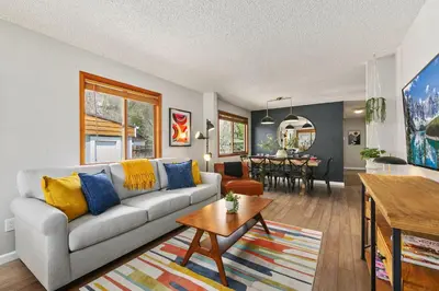 a living room with a couch and a table at Old Town Basecamp 6 Blocks to Old Town Square in Fort Collins