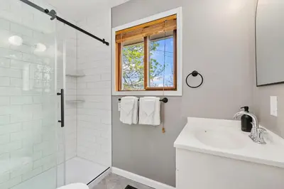 a white bathroom with a sink and a shower at Old Town Basecamp 6 Blocks to Old Town Square in Fort Collins