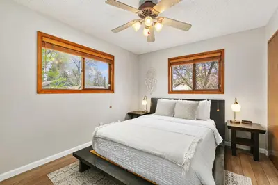 a bedroom with a bed and a ceiling fan at Old Town Basecamp 6 Blocks to Old Town Square in Fort Collins