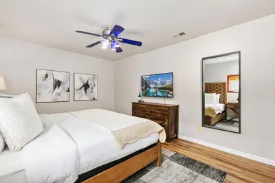 a bedroom with a bed and a ceiling fan at Old Town Basecamp 6 Blocks to Old Town Square in Fort Collins