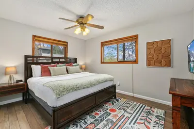 a bedroom with a bed and a ceiling fan at Old Town Basecamp 6 Blocks to Old Town Square in Fort Collins