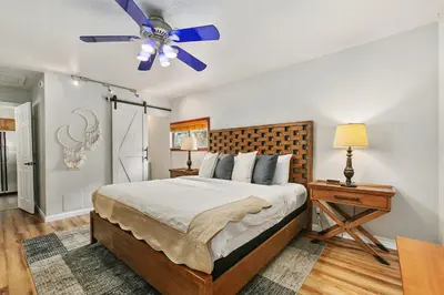 a bedroom with a bed and a ceiling fan at Old Town Basecamp 6 Blocks to Old Town Square in Fort Collins