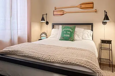 a bedroom with a bed with a green pillow on it at Shadow Mountain Marina in Grand Lake