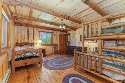 a bedroom with two bunk beds in a log cabin at Randalman House in Walden