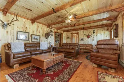 a living room with leather furniture and wooden ceilings at Randalman House in Walden