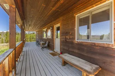 a porch of a cabin with a bench on it at Randalman House in Walden