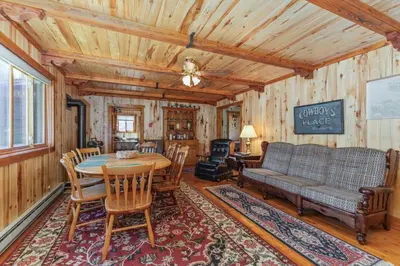 a living room with a table and a couch at Randalman House in Walden