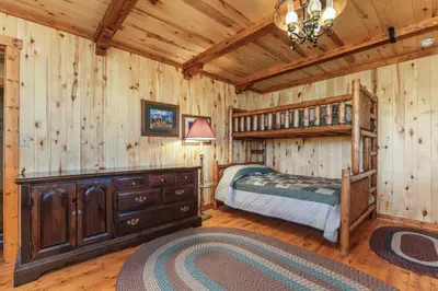 a bedroom with a bed and a wooden wall at Randalman House in Walden