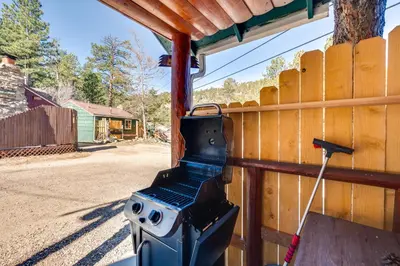 a grill on the side of a wooden fence at Private Hot Tub and Deck Riverfront Escape in Drake in Drake