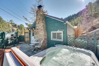 a hot tub on the deck of a tiny house at 4 Mi to Downtown Estes Park Nature Retreat in Drake
