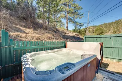 a jacuzzi tub sitting next to a fence at 4 Mi to Downtown Estes Park Nature Retreat in Drake
