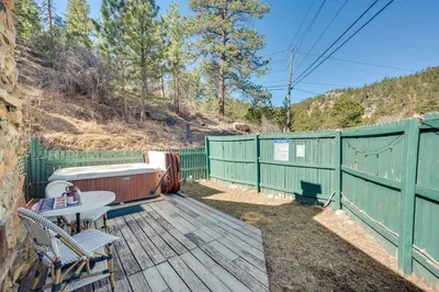 a deck with a table and chairs and a fence at 4 Mi to Downtown Estes Park Nature Retreat in Drake