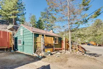 a green tiny house sitting on the side of a road at 4 Mi to Downtown Estes Park Nature Retreat in Drake