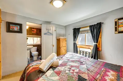 a bedroom with a bed with a quilt on it at 4 Mi to Downtown Estes Park Nature Retreat in Drake
