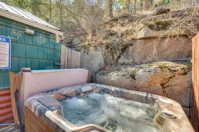 a bath tub with water in it next to a building at 8 Mi to Rocky Mountain Natl Park Serene Escape in Drake
