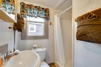 a bathroom with a sink and a toilet and a window at 8 Mi to Rocky Mountain Natl Park Serene Escape in Drake