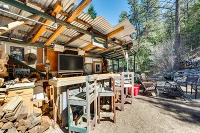 a kitchen with a table and chairs under a pergola at 8 Mi to Rocky Mountain Natl Park Serene Escape in Drake