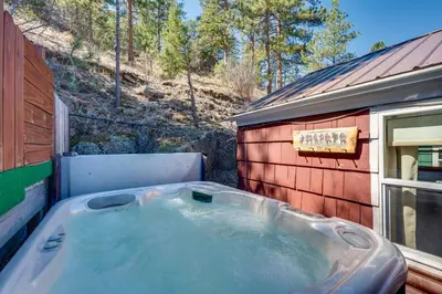 a hot tub sitting next to a red building at Private Hot Tub and Deck Romantic Getaway in Drake in Drake