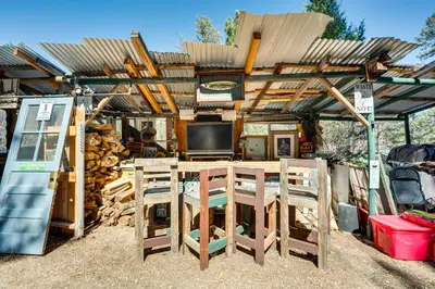 a wooden pergola with a table and chairs at Private Hot Tub and Deck Romantic Getaway in Drake in Drake