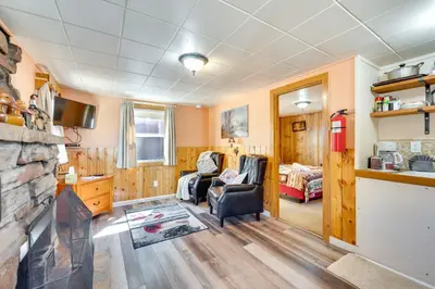 a living room with a couch and a fireplace at Private Hot Tub and Deck Romantic Getaway in Drake in Drake