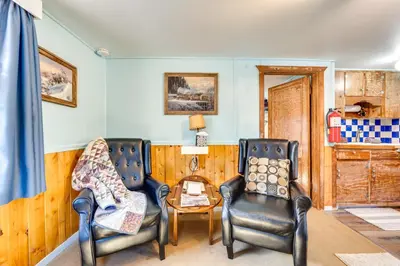 a living room with two chairs and a table at Fish, Hike and Unwind Drake Cabin with Hot Tub! in Drake