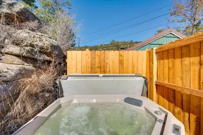 a hot tub in front of a wooden fence at Fish, Hike and Unwind Drake Cabin with Hot Tub! in Drake