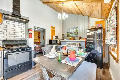 a kitchen with a table with hats on it at Private Hot Tub and Fishing On-Site Cabin in Drake in Drake