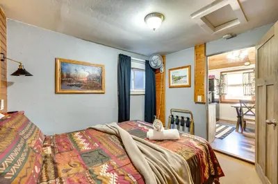 a bedroom with a bed with a blanket on it at Private Hot Tub and Fishing On-Site Cabin in Drake in Drake